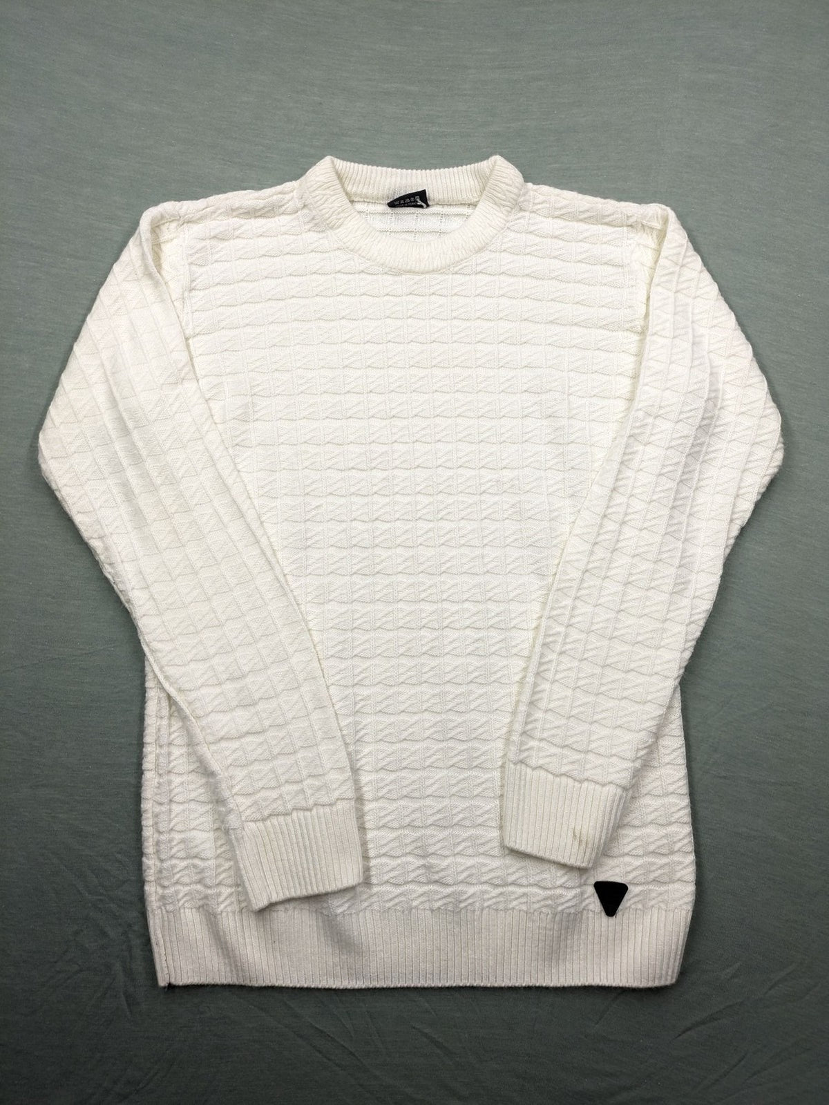 Haskalkan white turtle neck jumper with geometric textured pattern and ribbed cuffs.