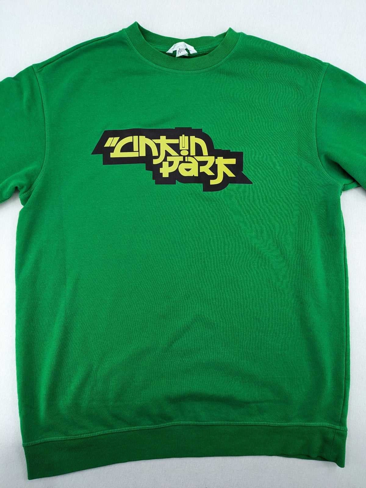 Linkin Park green sweatshirt featuring iconic band logo and classic crew neck design.