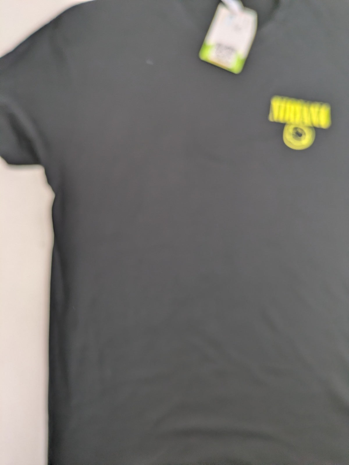 Smiley grey band t-shirt featuring yellow Nirvana smiley face logo on chest.