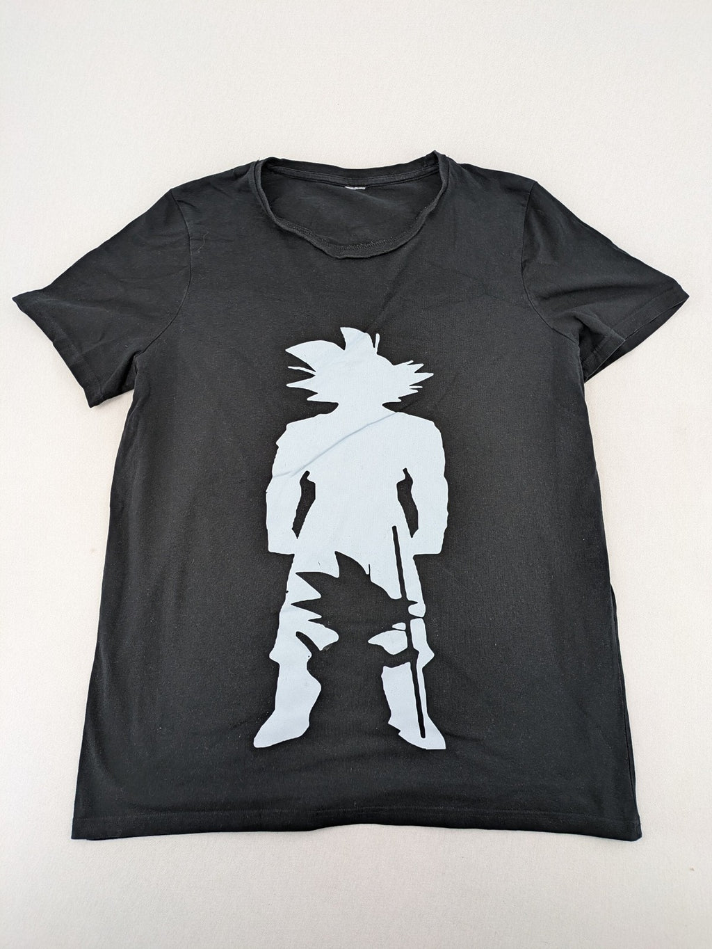 Dragon Ball Z black t-shirt featuring blue Son Goku silhouette graphic design.