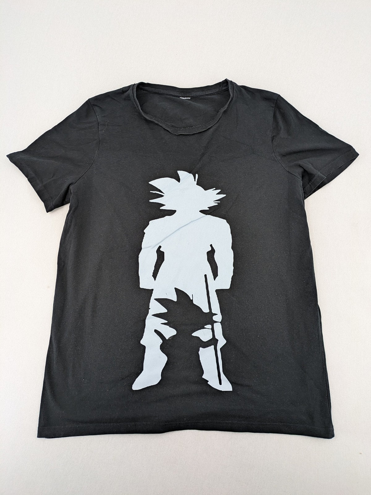 Dragon Ball Z black t-shirt featuring blue Son Goku silhouette graphic design.