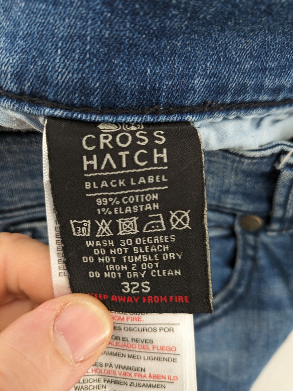 Crosshatch blue slim fit jeans with faded wash and logo patch on back pocket.
