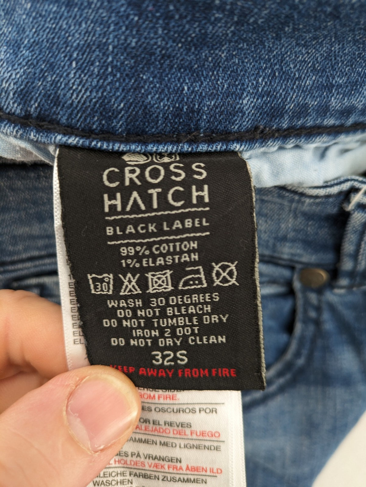 Crosshatch blue slim fit jeans with faded wash and logo patch on back pocket.