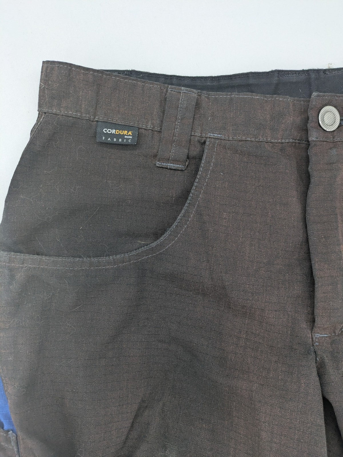 Kübler work pants blue grey Cordura fabric with multiple cargo pockets and reflective details.