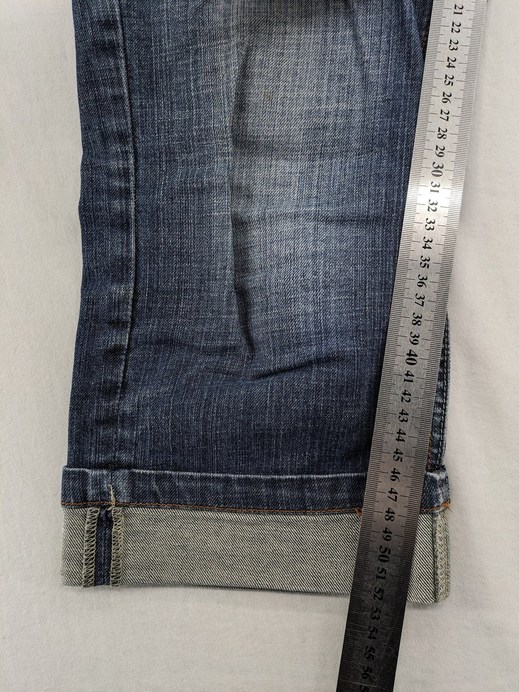 BLU blue straight jeans with washed effect, rolled hem, and five-pocket design.