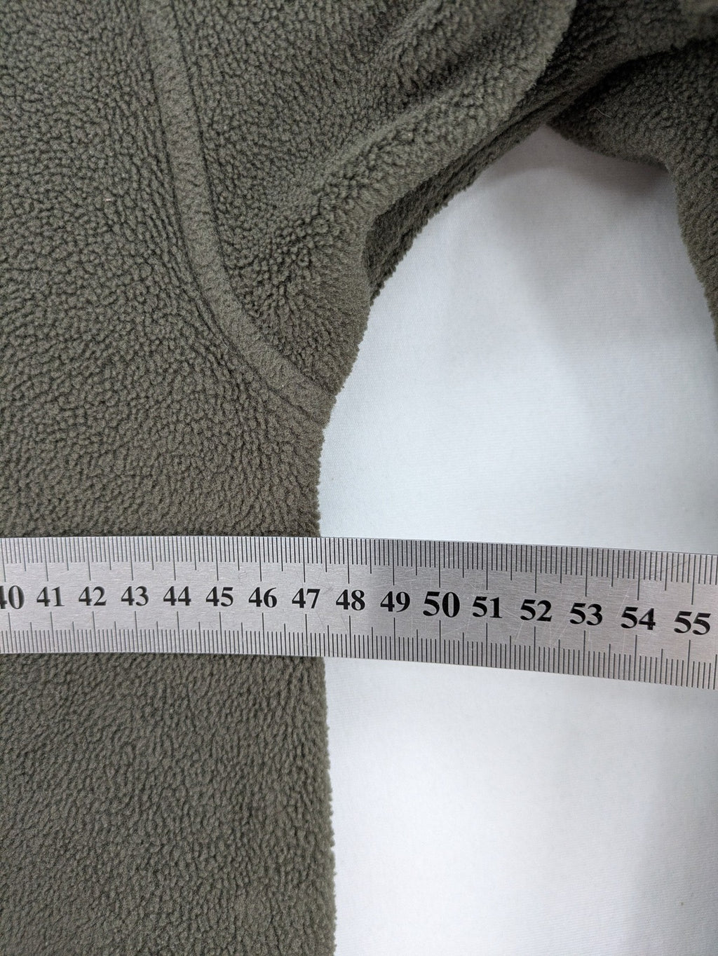 Jack Wolfskin khaki turtle neck jumper with quarter zip and embroidered paw logo.