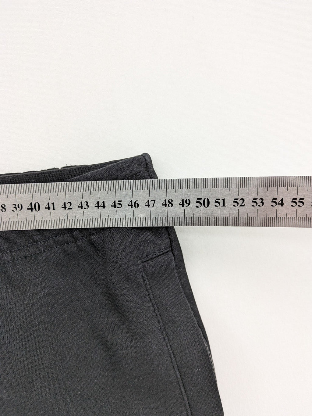 K1X grey joggers with white basketball logo, elastic waistband, and cuffed ankles.