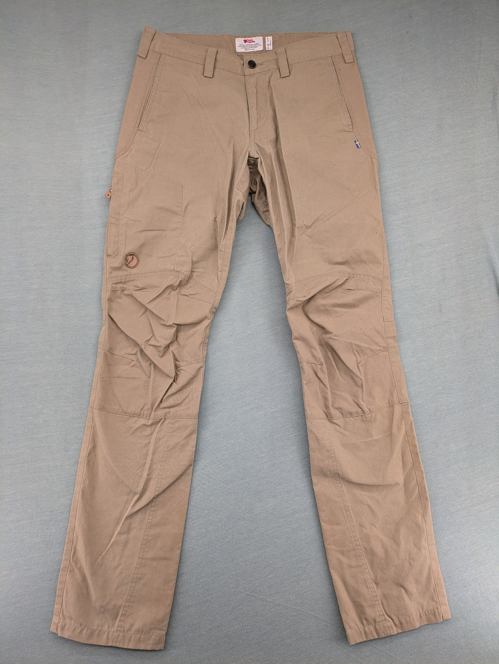 Fjällräven beige pants regular fit durable fabric outdoor style with logo detail.