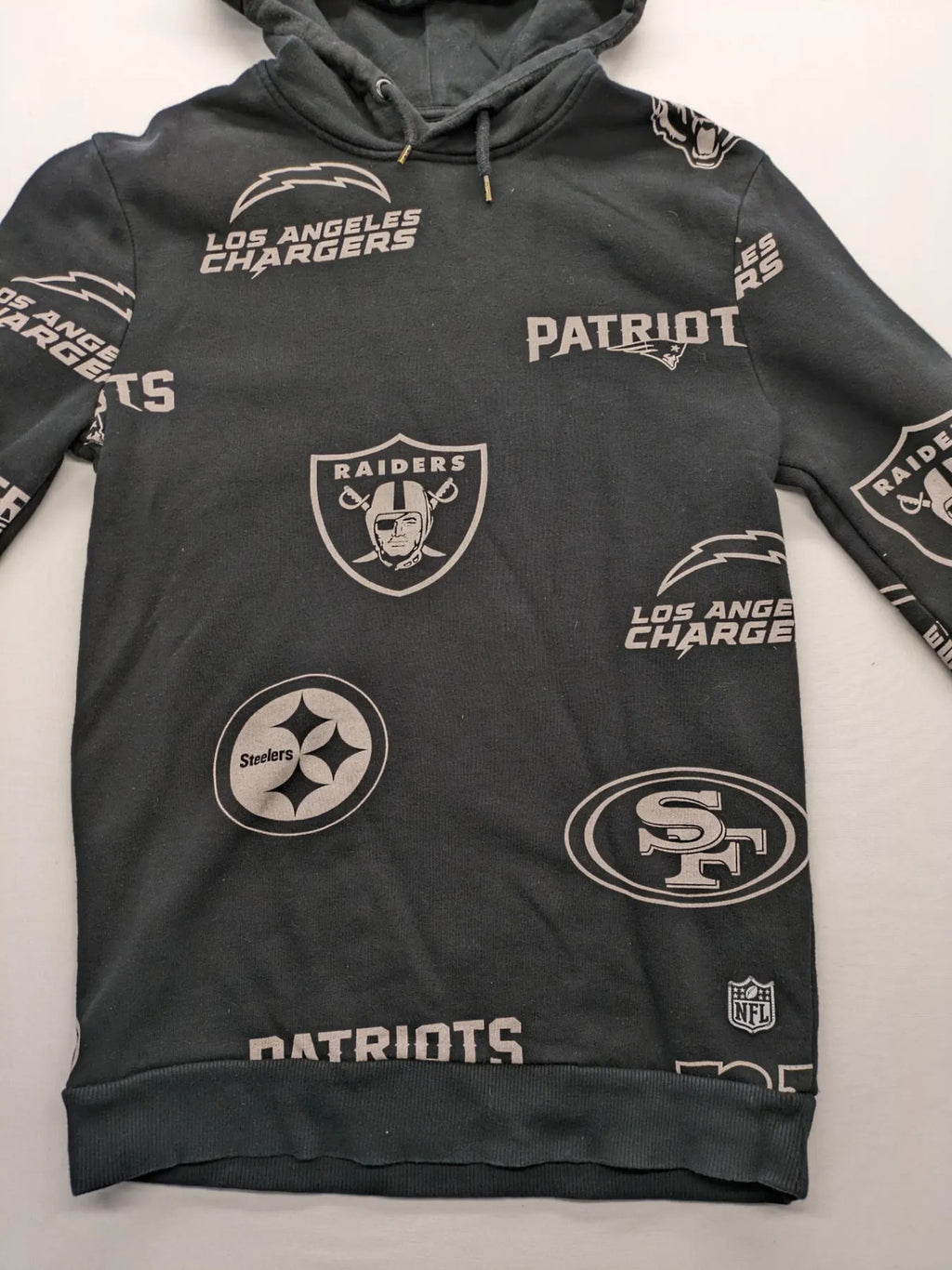 NFL black hoodie all-over team logo print, adjustable hood, cotton blend material.