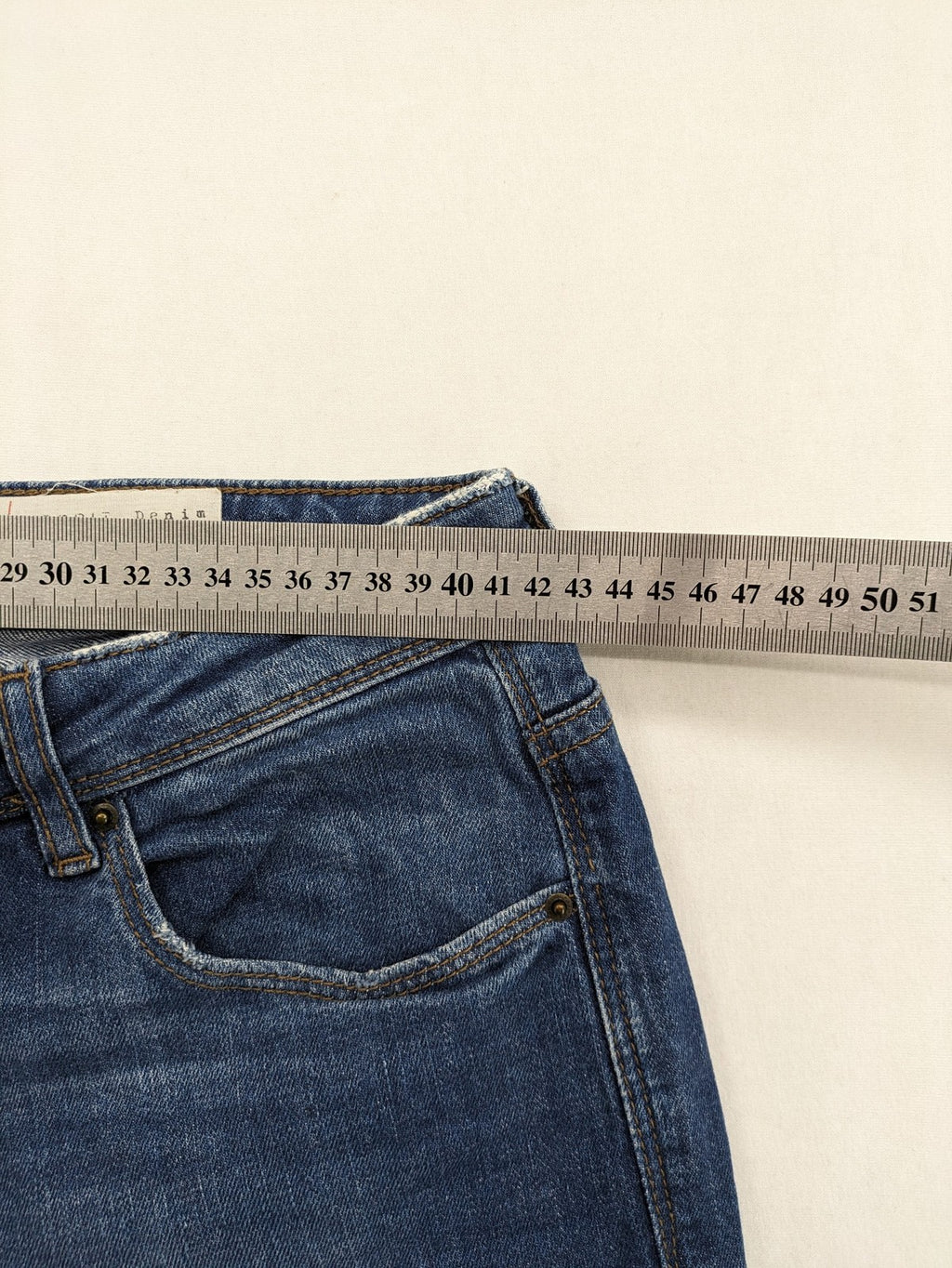 Esprit blue straight leg jeans with ripped knee details and rolled hem.