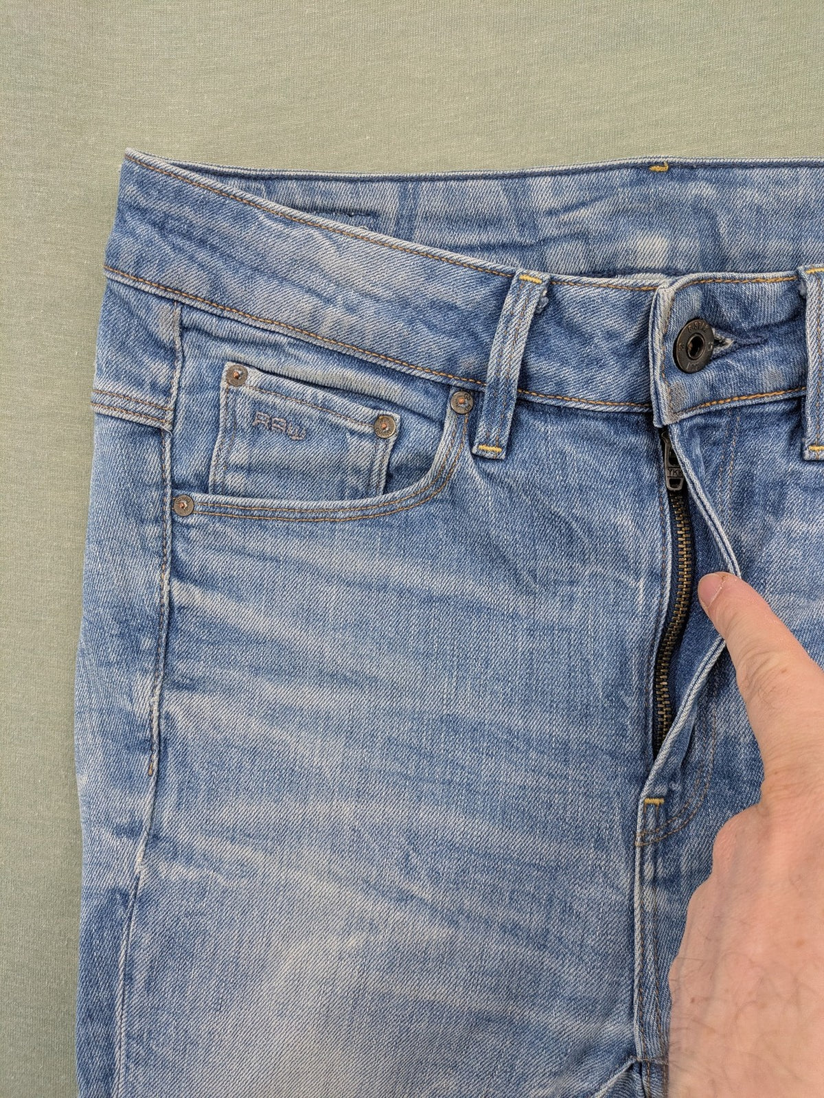 G-Star Raw blue slim skinny jeans with light wash and signature back zip pocket.