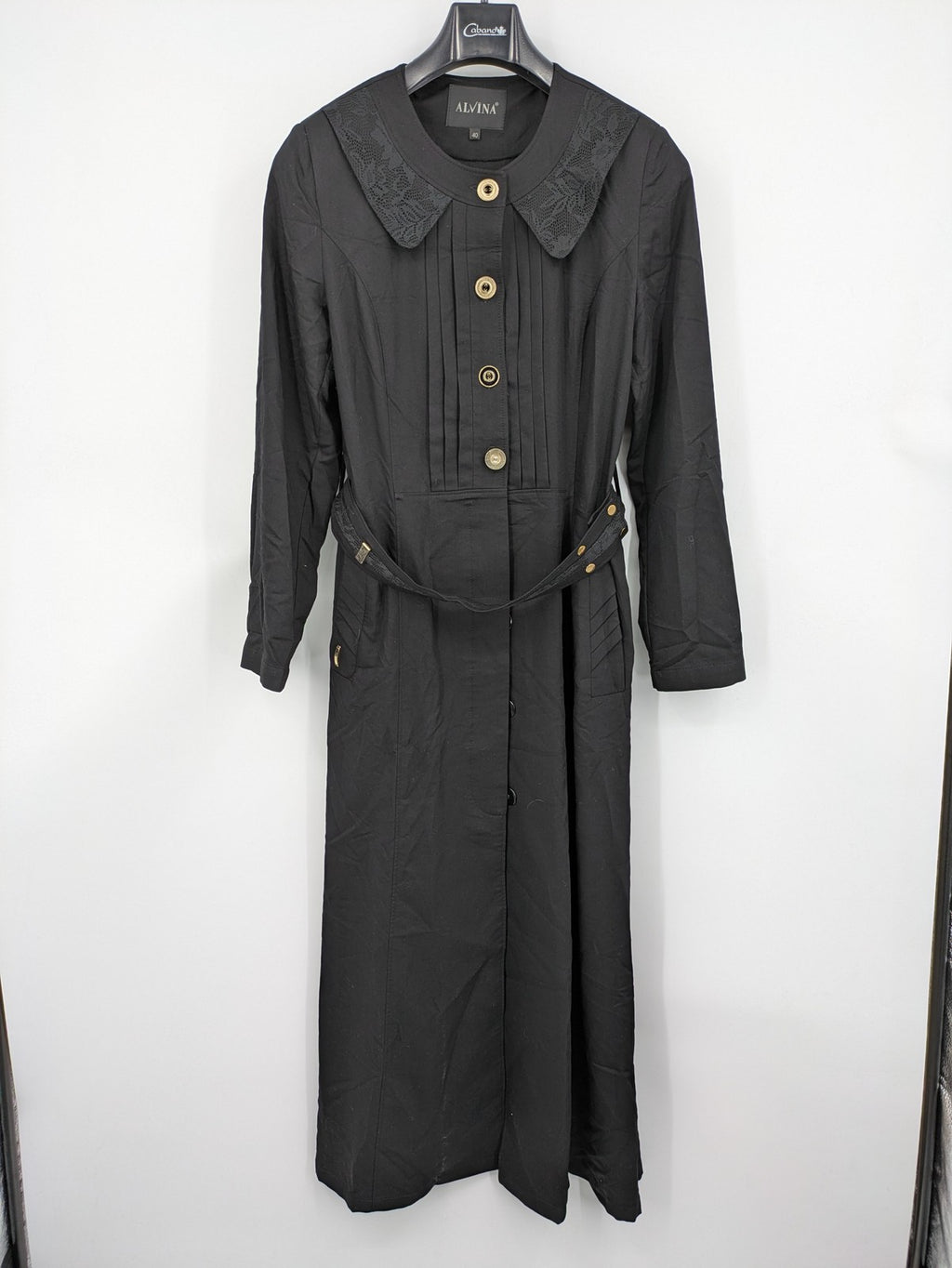 Alvina black trench coat with lace collar and gold buttons, belted waist design.