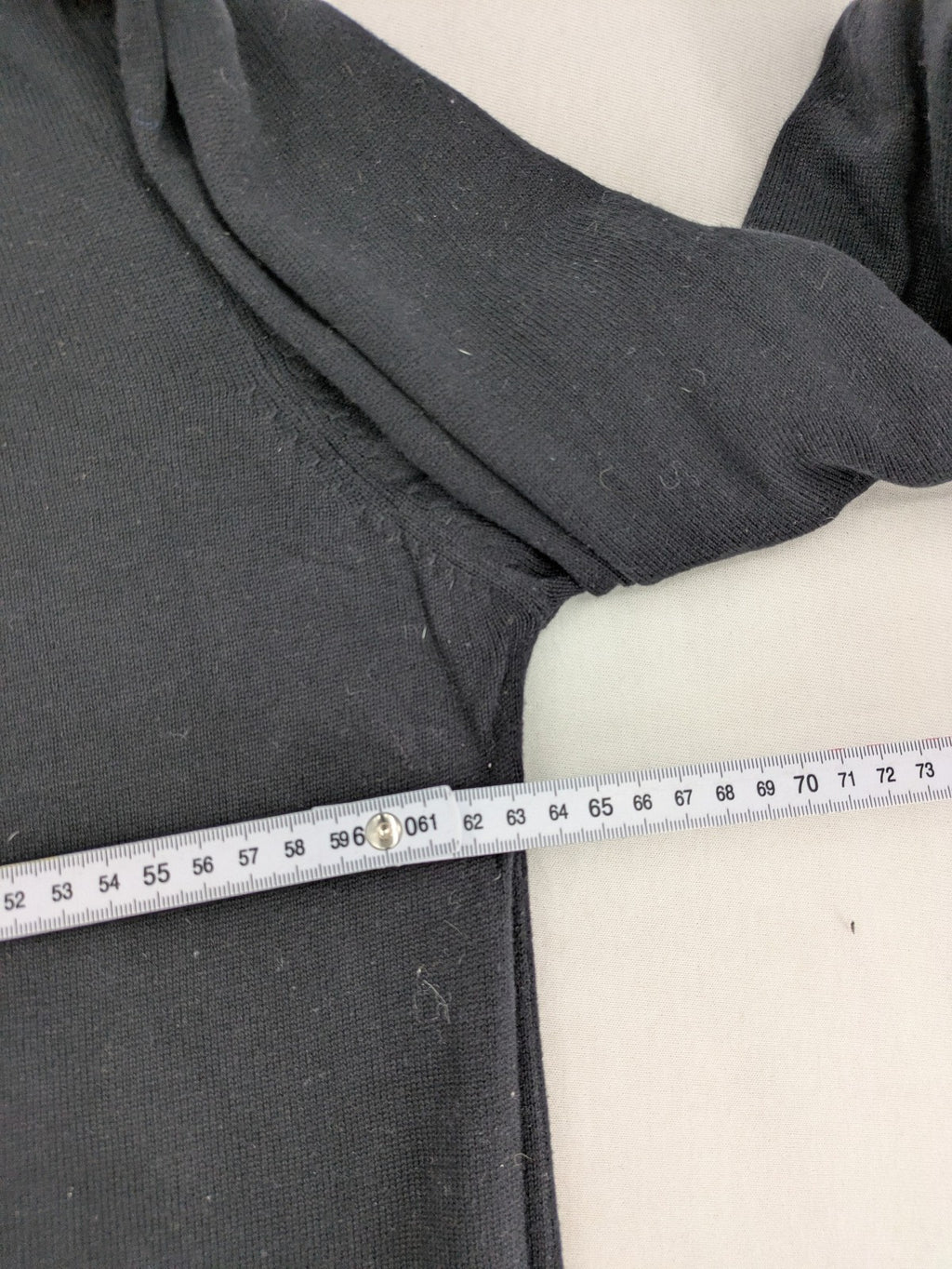 Angelo Litrico black knit jumper V-neck with tonal emblem and "Supreme Oil Quality" graphic.