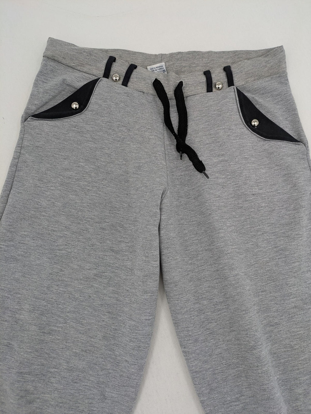 Falconhill grey jogging pants with elastic waistband, drawstring, and stylish black accent pockets.