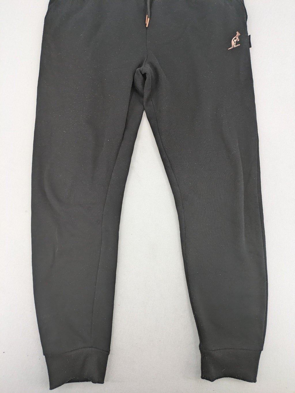 Kuyruun black jogging pants with kangaroo logo, elastic waistband, and ribbed cuffs.