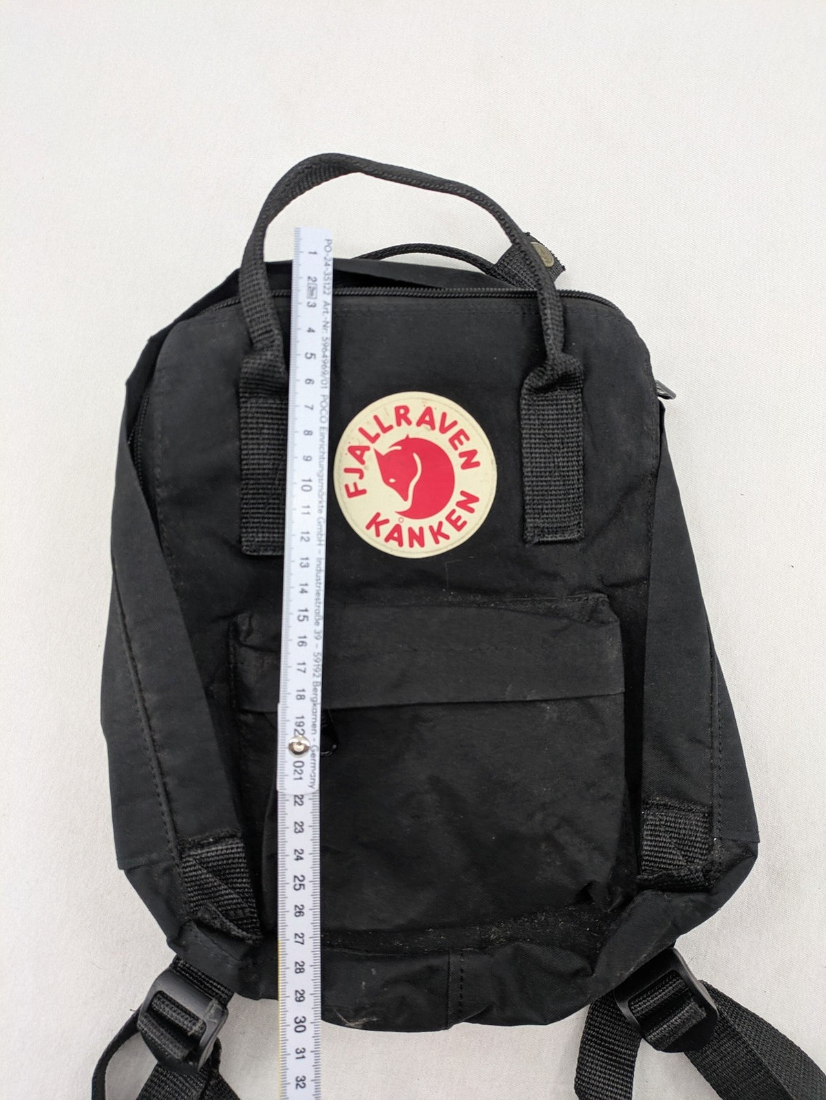 Fjällräven Kånken Mini rucksack black durable fabric with logo and zippered main compartment.