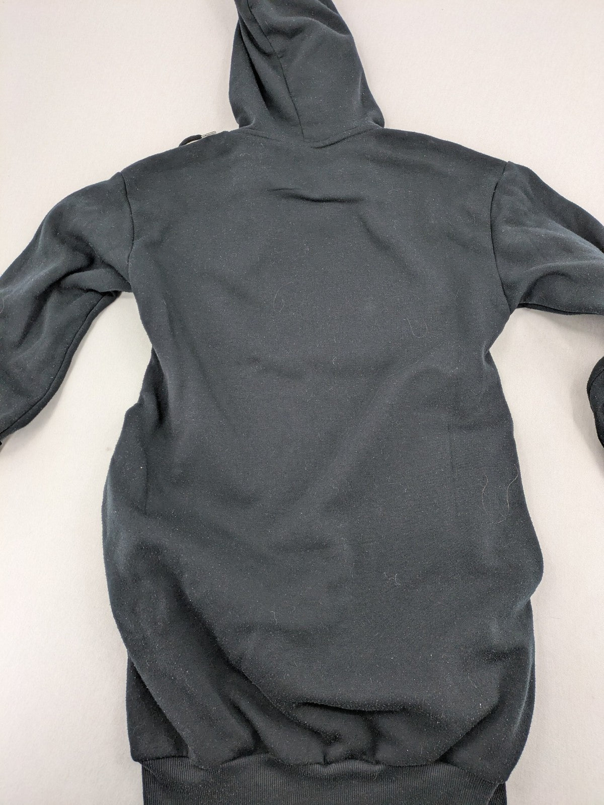 One Piece long hoodie black featuring Trafalgar Law's Jolly-Roger logo and drawstring hood.
