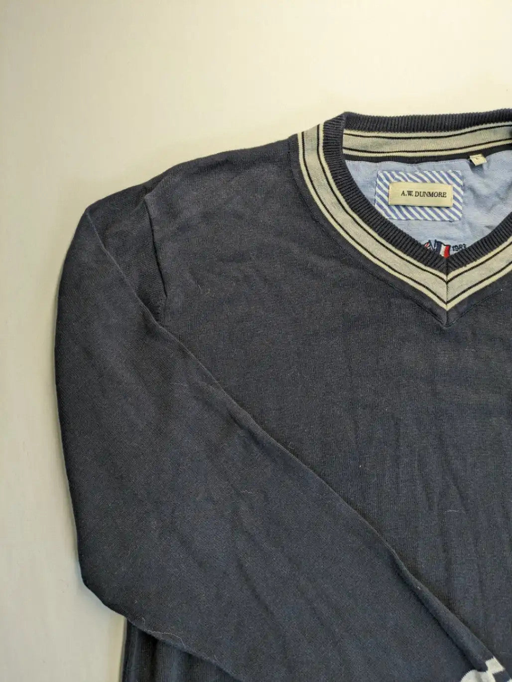 dunmore turtle neck jumper dark blue with striped trims and embroidered crest logo