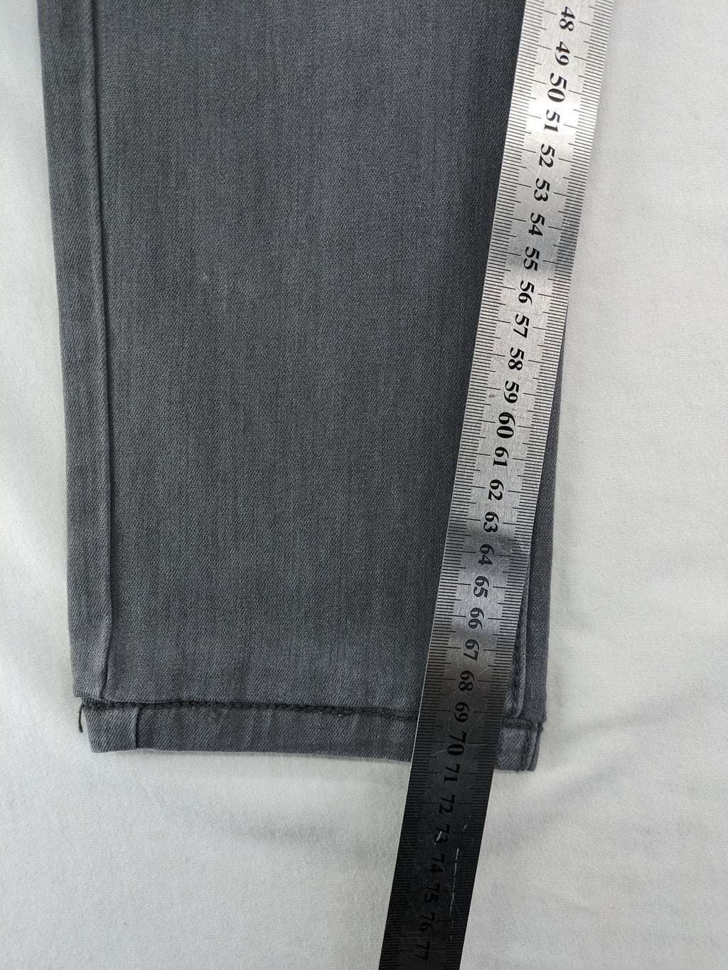 Born Rich grey slim fit jeans with button fly and washed denim texture.