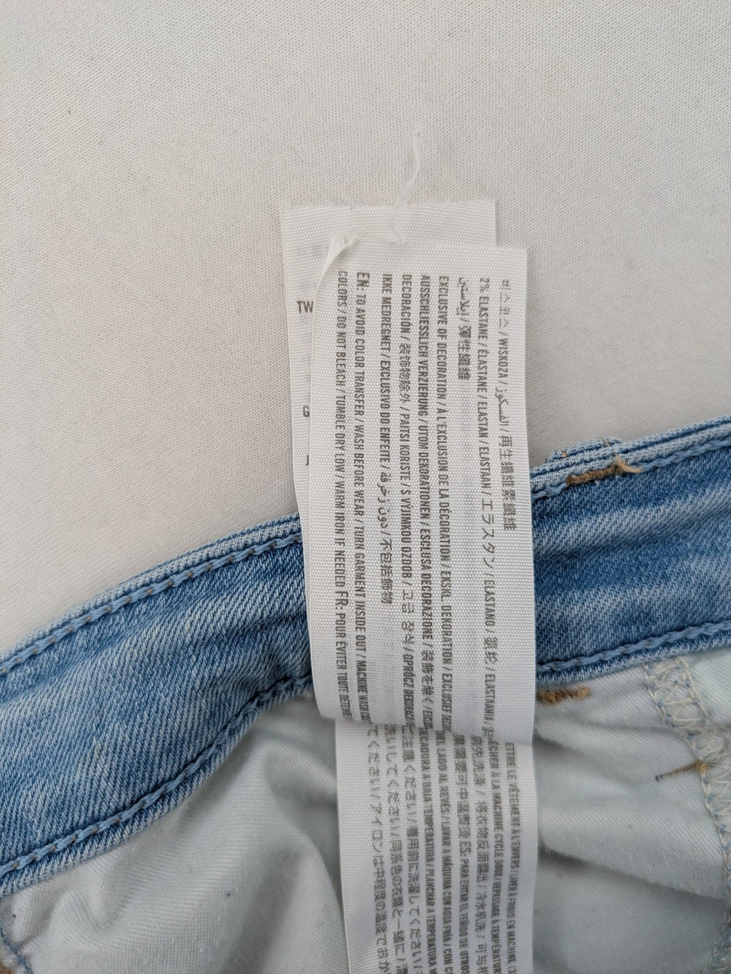 Hollister blue high-rise crop super skinny jeans with distressed rips and frayed hem.