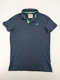 Hollister polo shirt navy blue with embroidered seagull logo and green trim.
