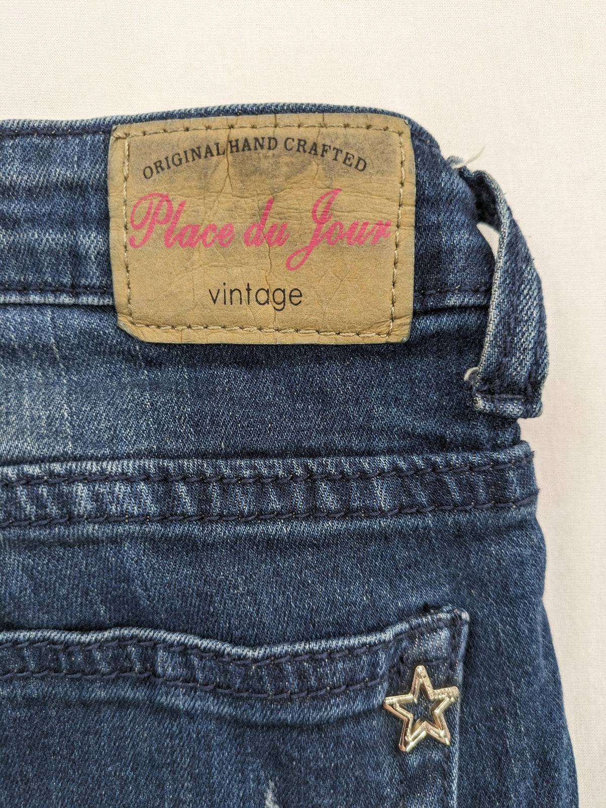Place du Jour blue biker jeans with zippers, used-look wash, and star rivet detail.
