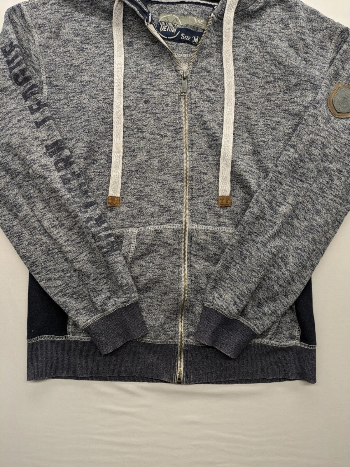 Tom Tompson cream turtle neck jumper with dark blue accents and graphic details on sleeve.