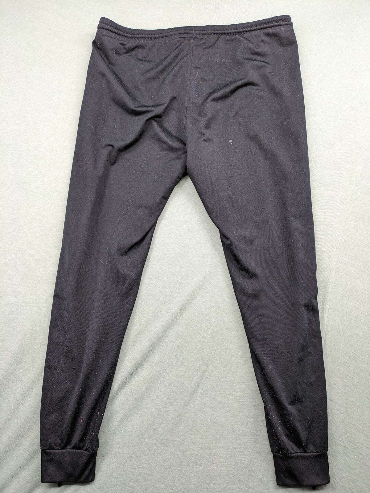 Jako black training pants size L with zippered pockets and elastic waistband.