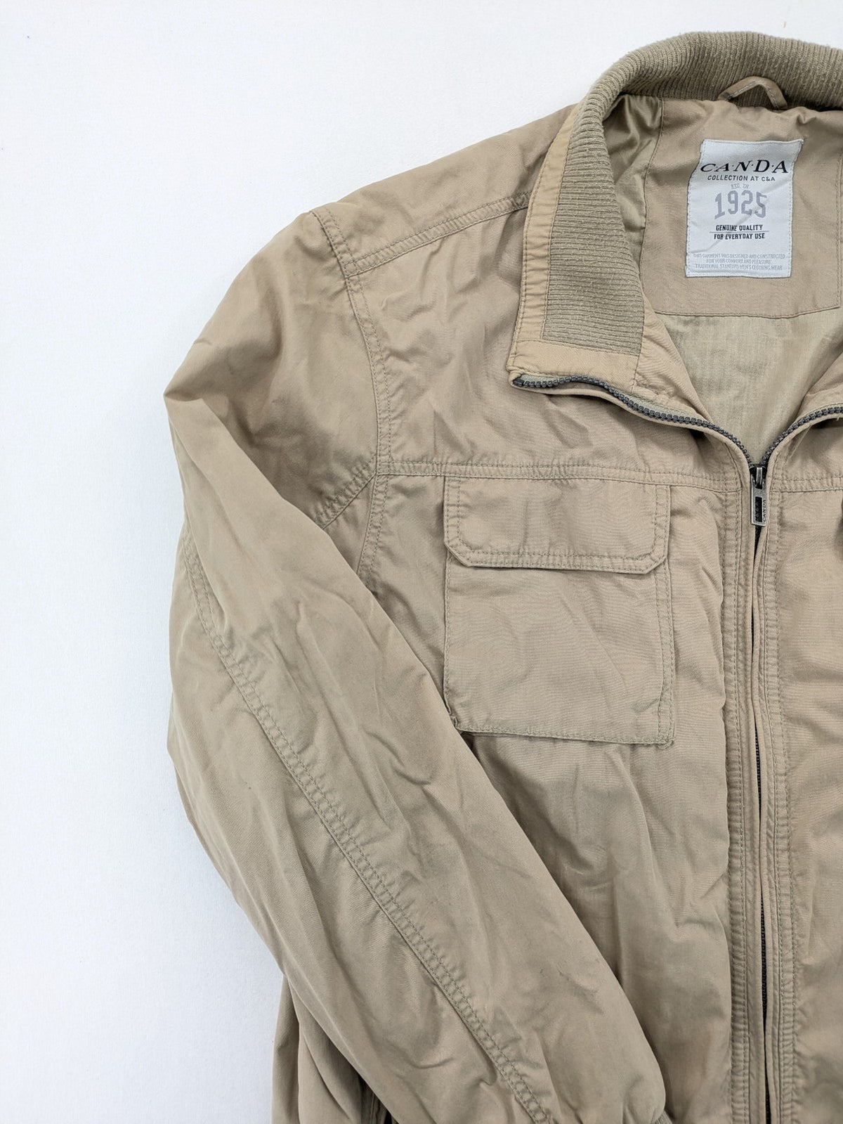 Canda beige bomber jacket full zip with ribbed collar and buttoned chest pockets.