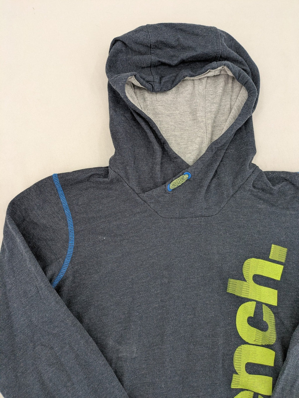 Bench hoodie dark grey with neon green logo and blue contrast stitching.
