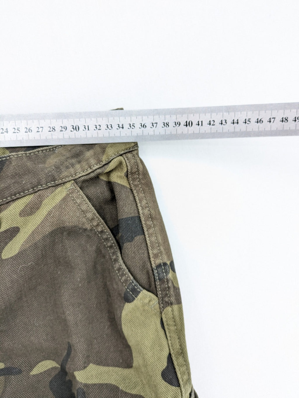 Rainbow camouflage cargo pants in green-brown with jogger silhouette and multiple pockets.