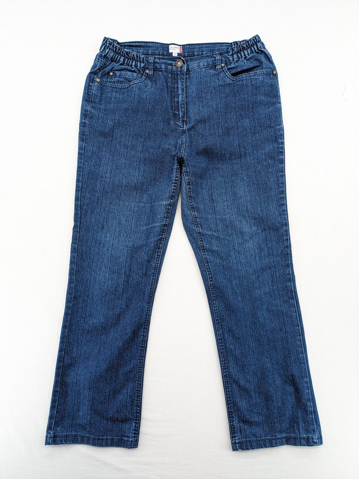 Outfit blue straight jeans with elastic waistband and embroidered crown-wing emblem on pockets.