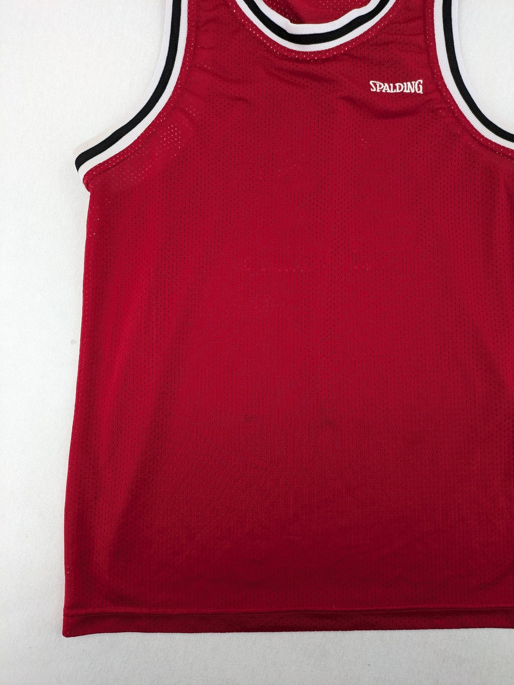Spalding vintage red basketball jersey size XL, number 11, with black and white striped trim.