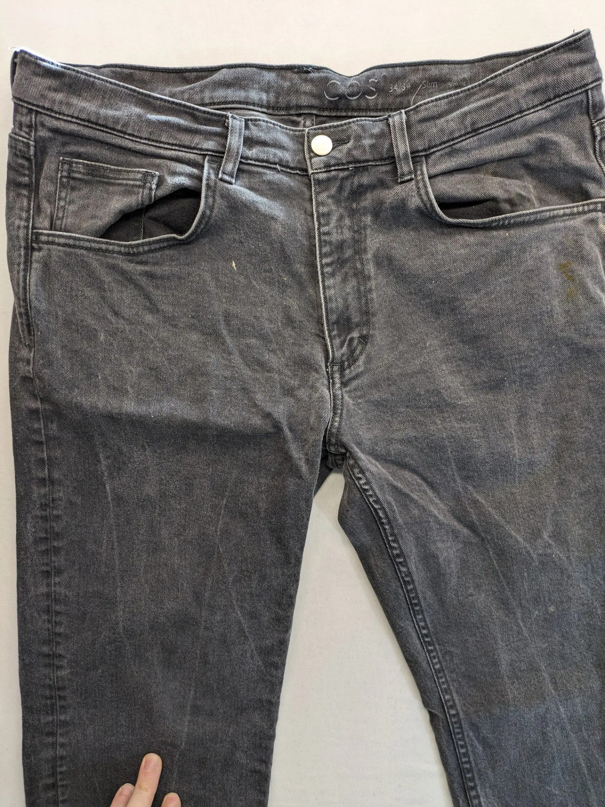 COS grey straight jeans with classic 5-pocket style and washed denim texture.