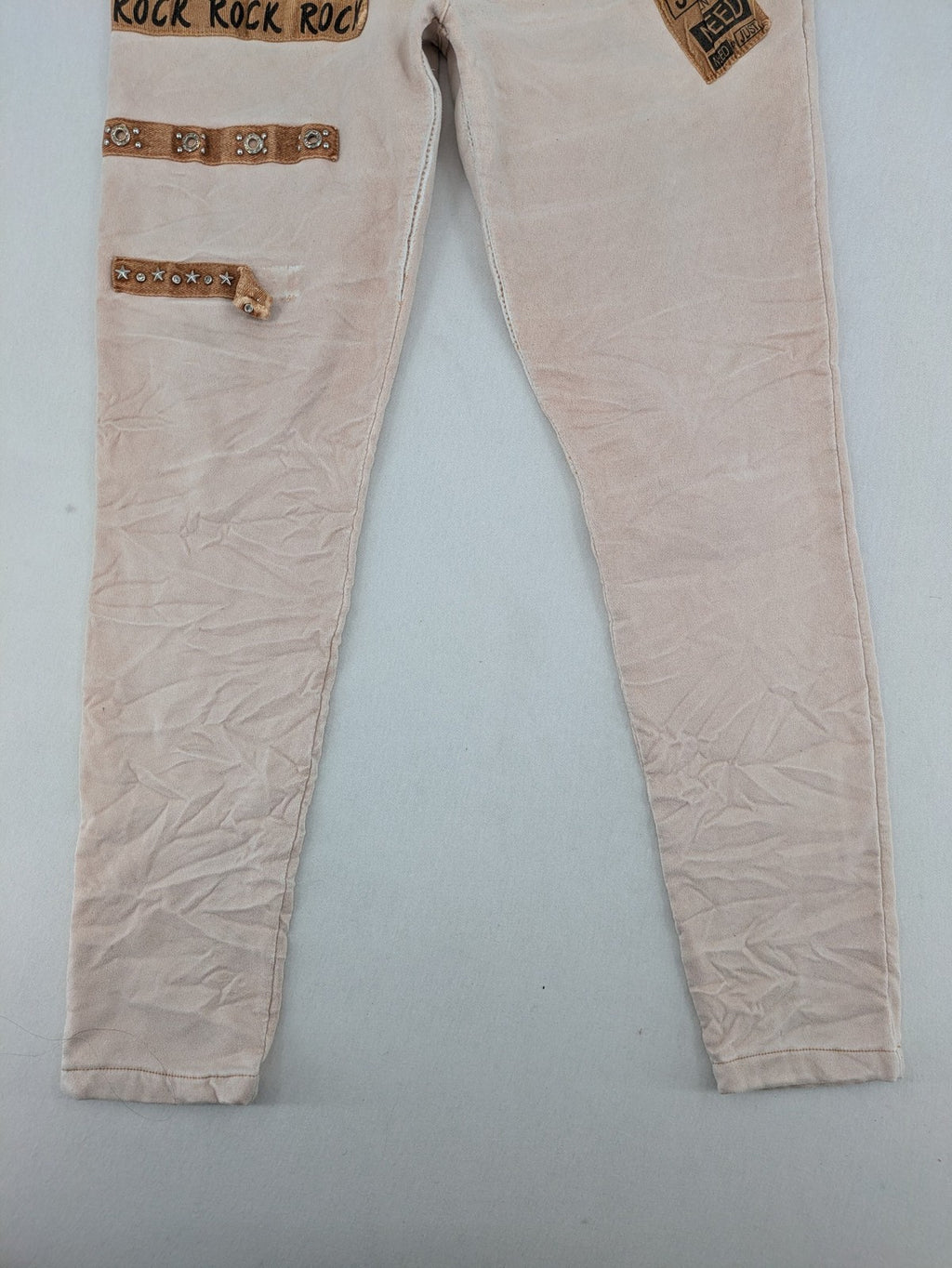 Made In Italy beige pants with crinkle texture and rock-style patches, drawstring waist.
