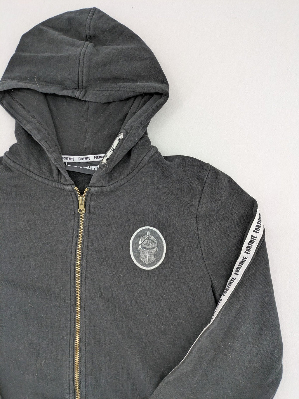 Fortnite black zip-through hoodie with logo on sleeves and Black Knight patch on chest.
