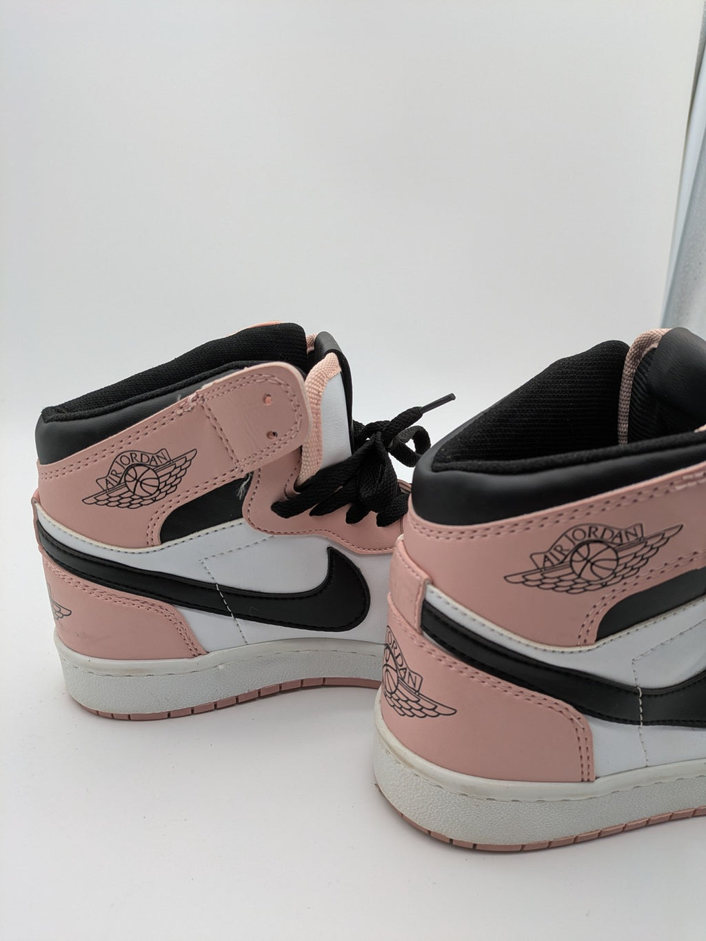 Nike Air Jordan high-top sneakers multi with Wings logo, Jumpman detail, and perforated toe.