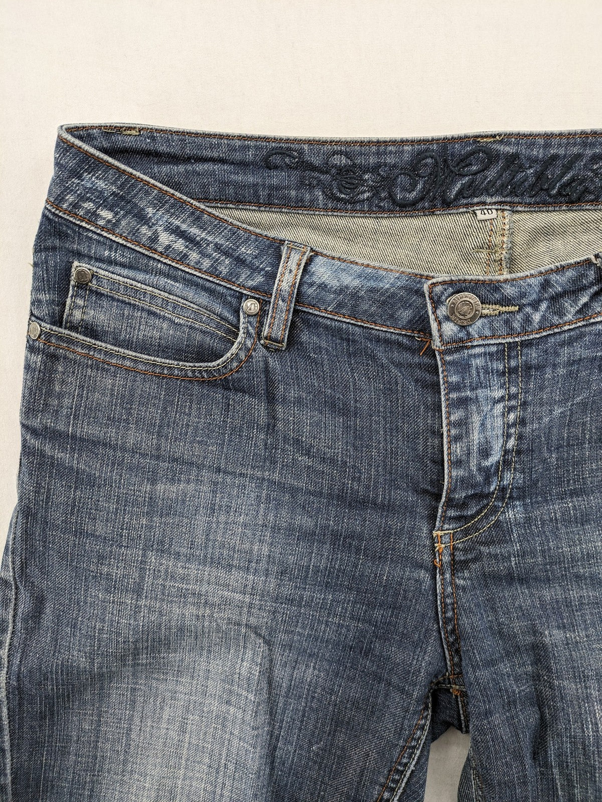 BLU blue straight jeans with washed effect, rolled hem, and five-pocket design.