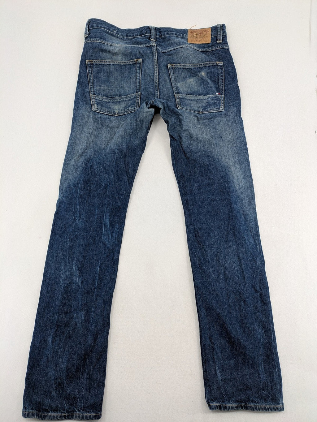 Hilfiger Denim blue straight jeans faded wash with Tommy Hilfiger flag logo on pocket.