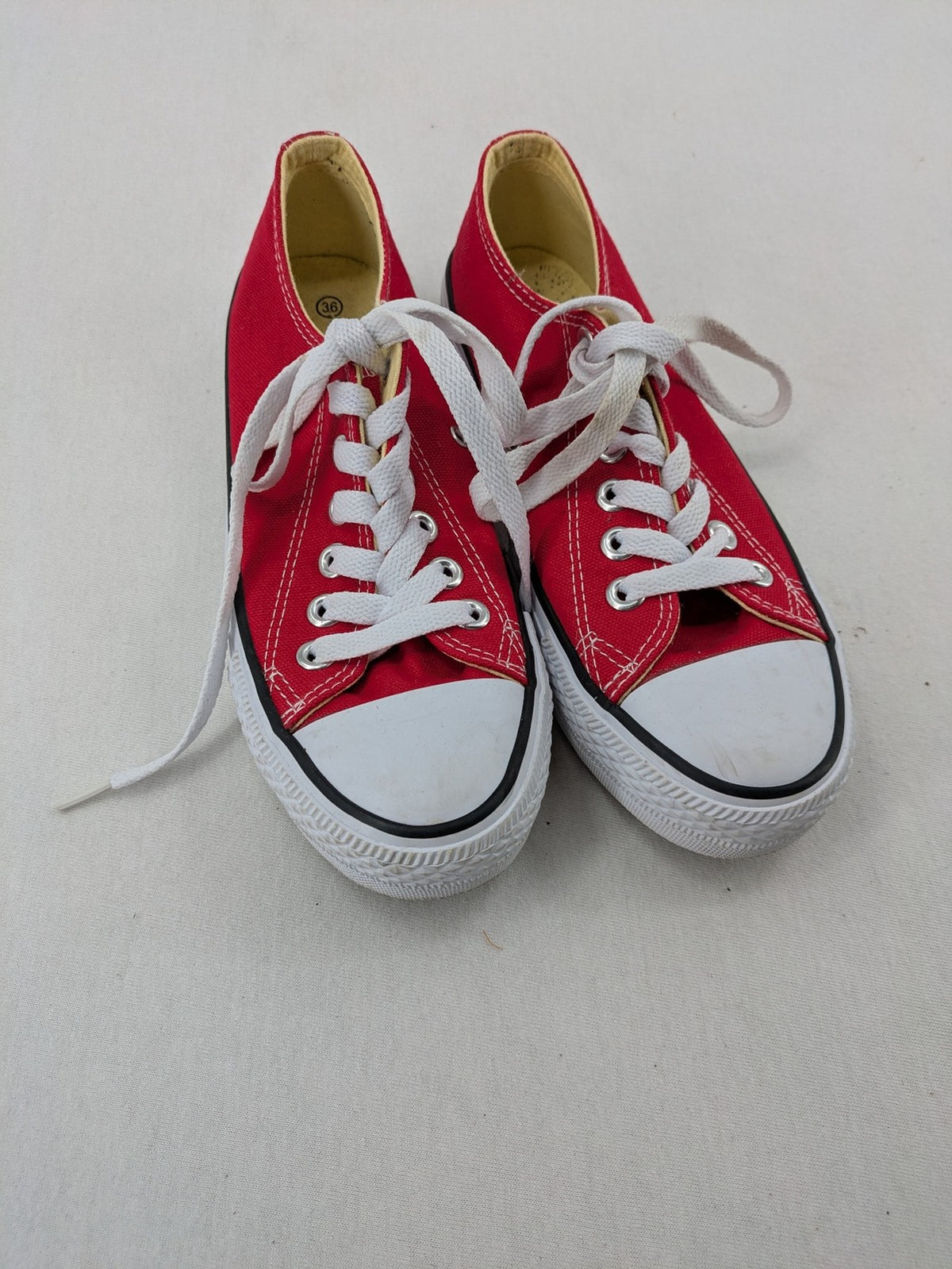 Sneaker low-top canvas sneakers red upper with white laces and rubber sole