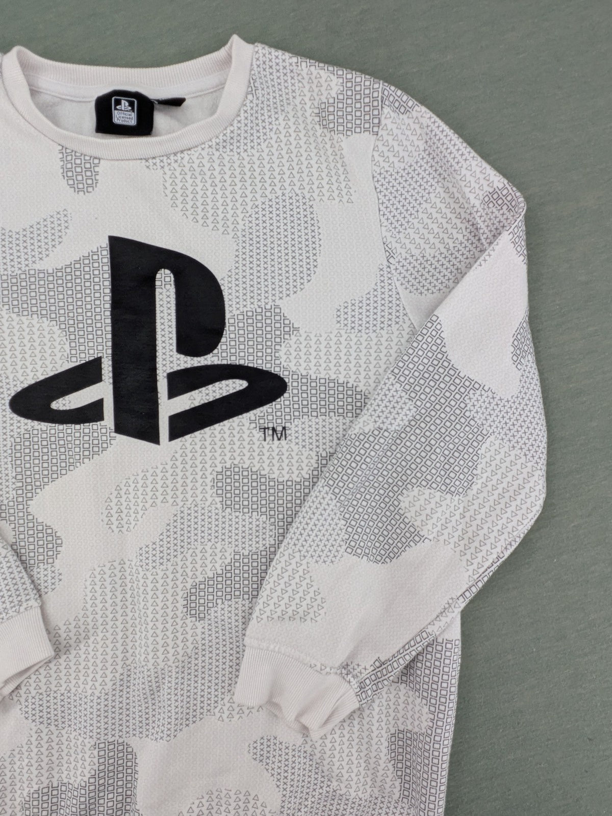 PlayStation grey sweatshirt with white logo and camo pattern featuring controller symbols.