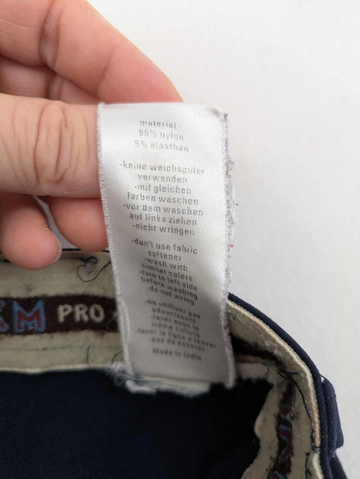 H&KM beige riding pants with dark blue full seat and front zippers.