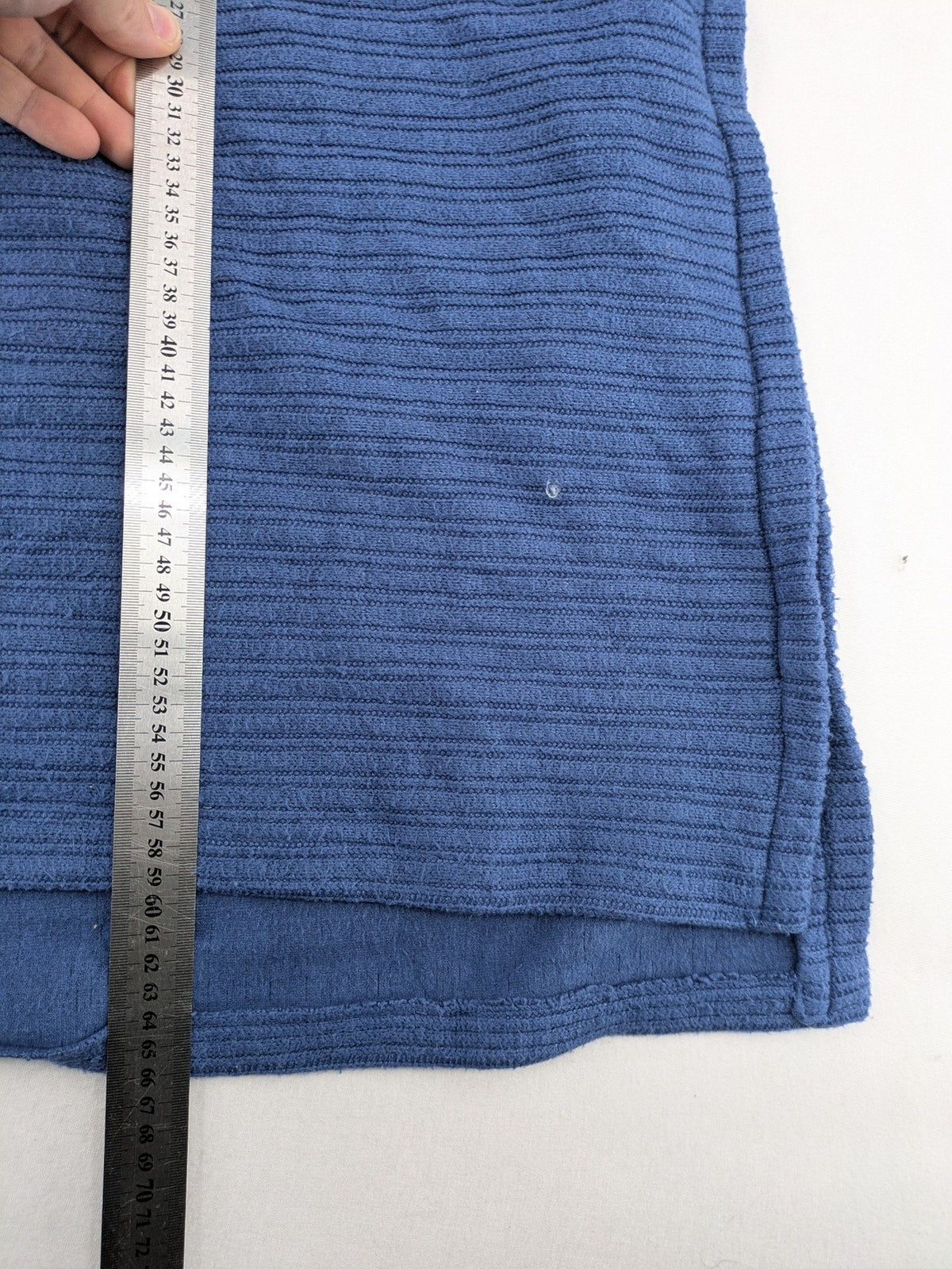 Secondhand blue tank top with ribbed texture and colorful decorative buttons.