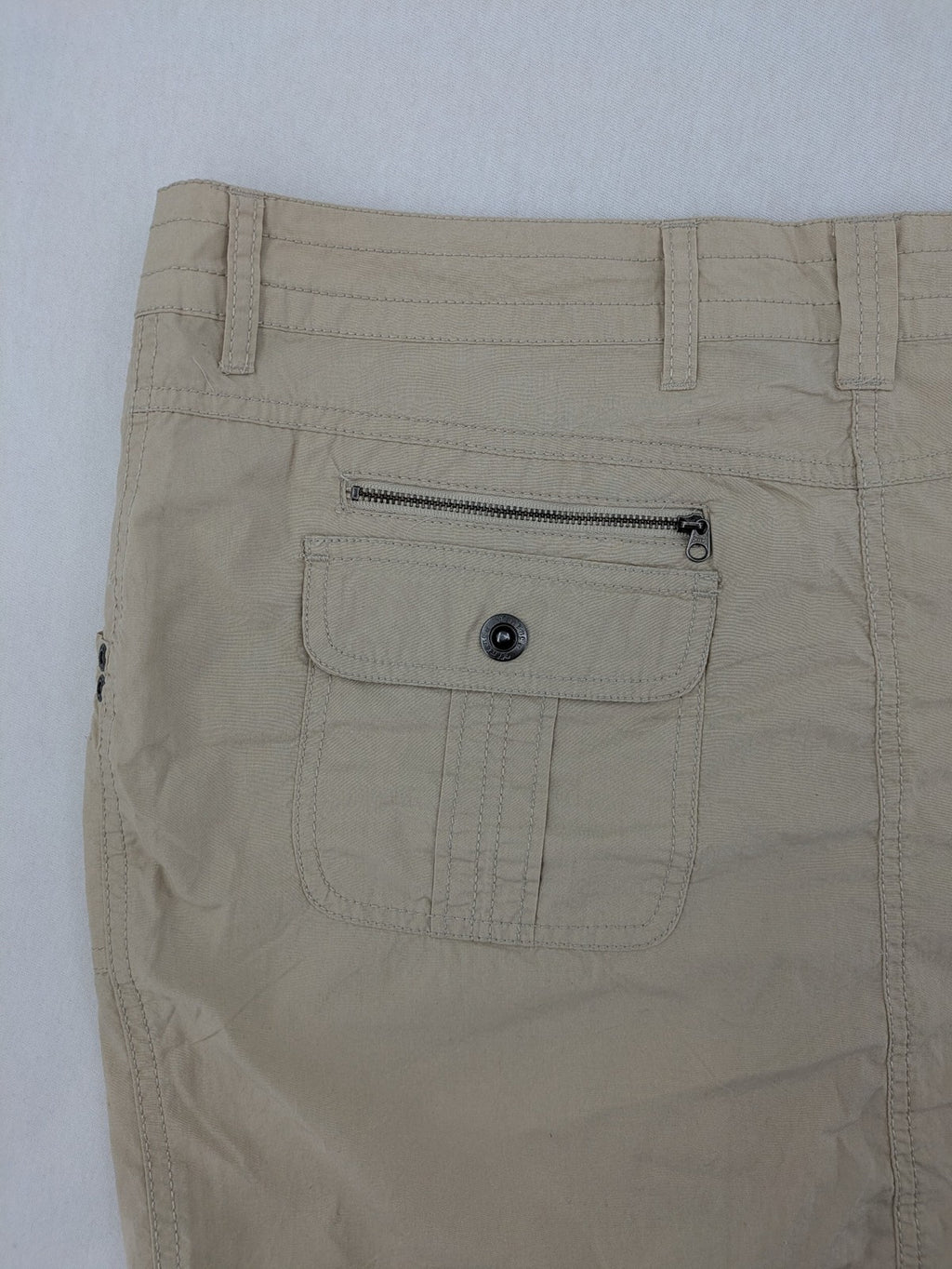 ESMARA beige cargo mini skirt with utility pockets and classic zipper button closure.