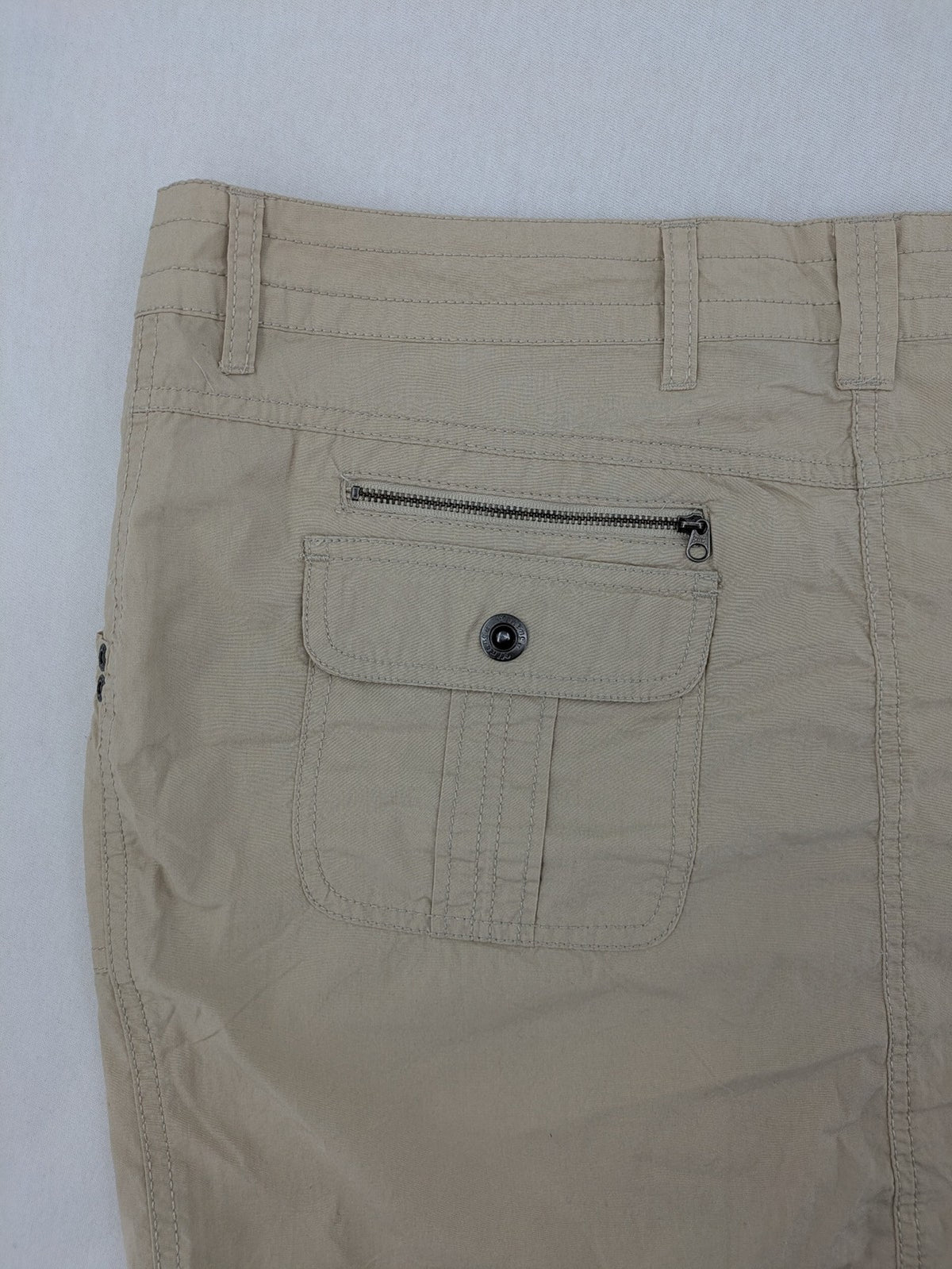 ESMARA beige cargo mini skirt with utility pockets and classic zipper button closure.