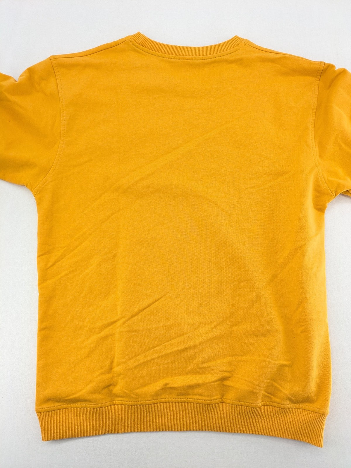 Columbia yellow turtle neck jumper with iconic logo, ribbed cuffs, and soft cotton material.