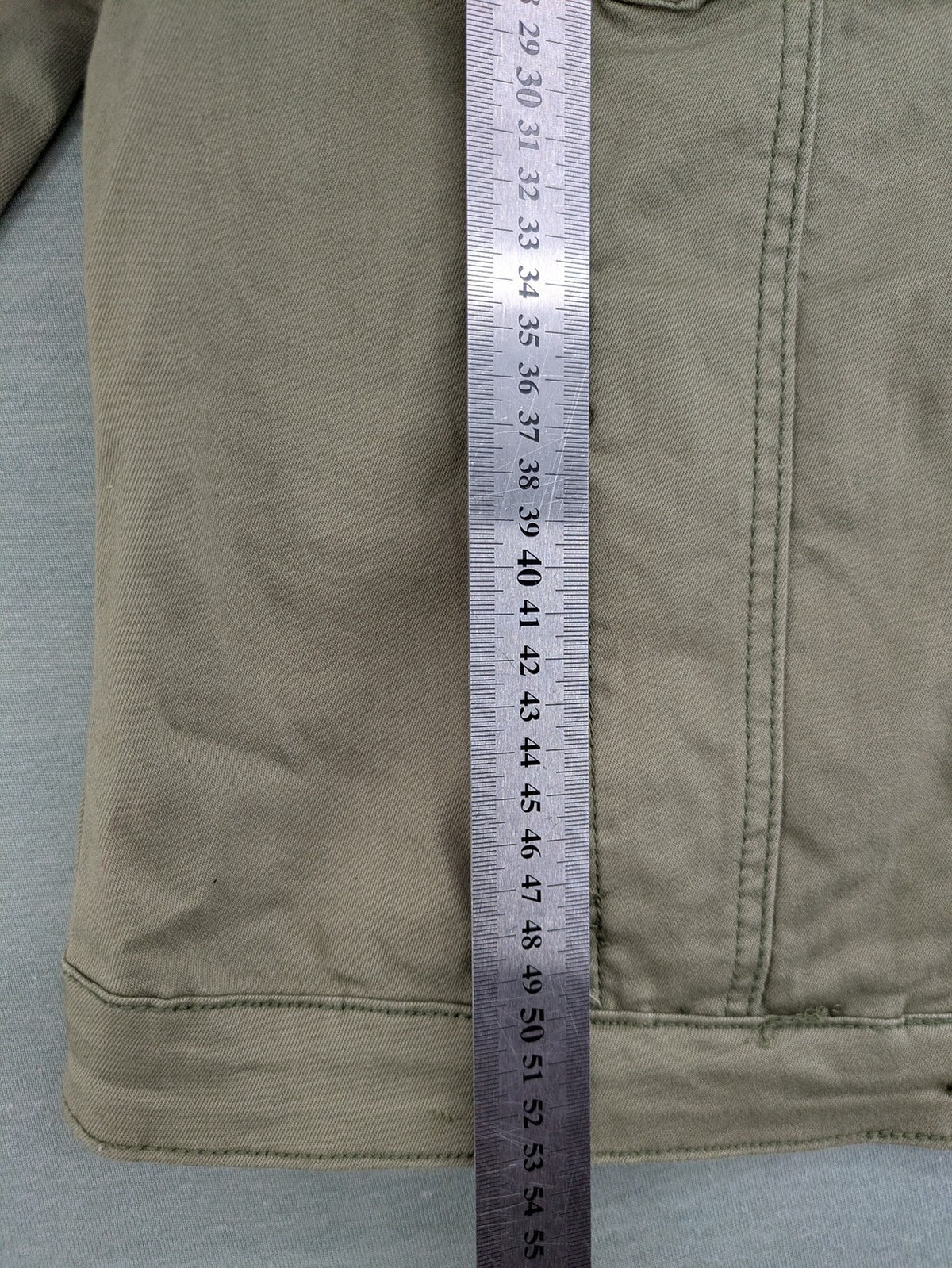 Hailys khaki denim jacket with button closure, two chest pockets, and side pockets.