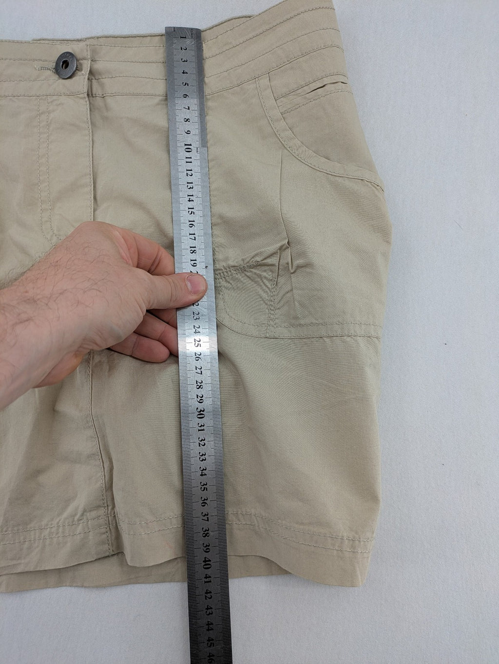 ESMARA beige cargo mini skirt with utility pockets and classic zipper button closure.