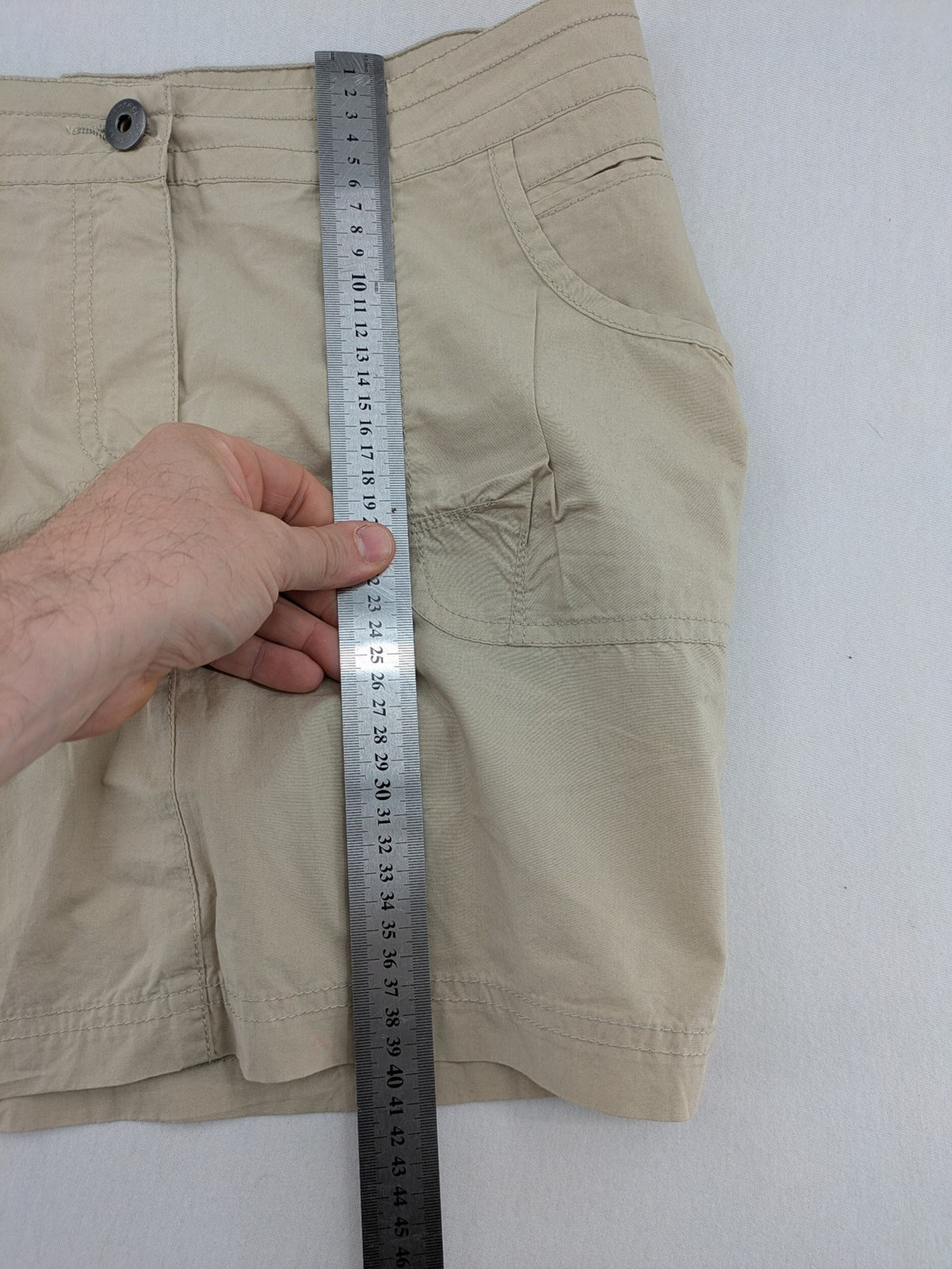 ESMARA beige cargo mini skirt with utility pockets and classic zipper button closure.