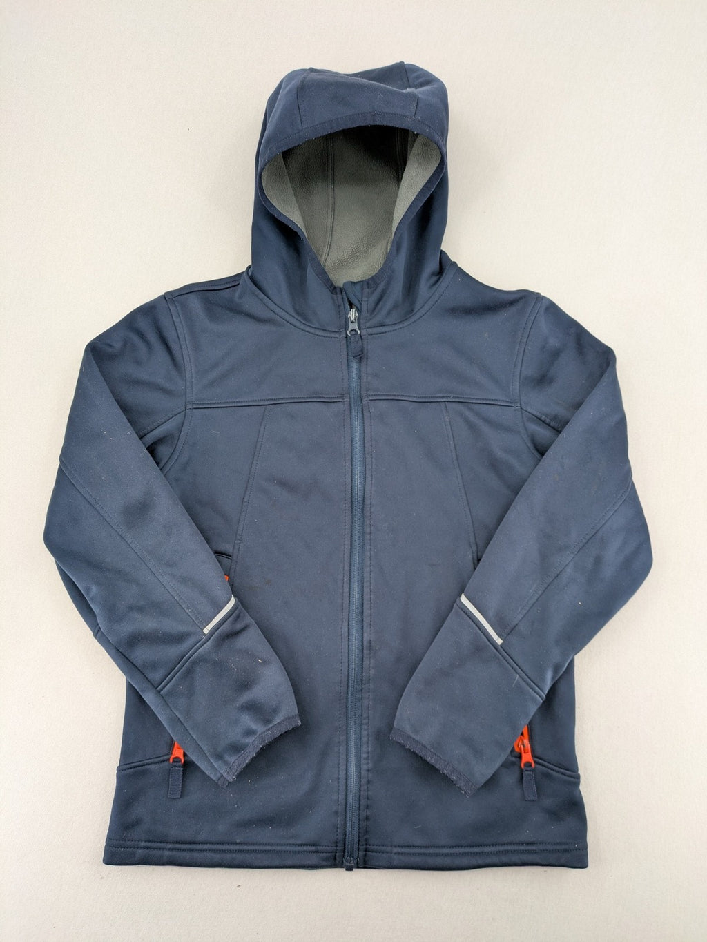 Crane navy softshell jacket with fleece lining, full zip, orange accent zippers.